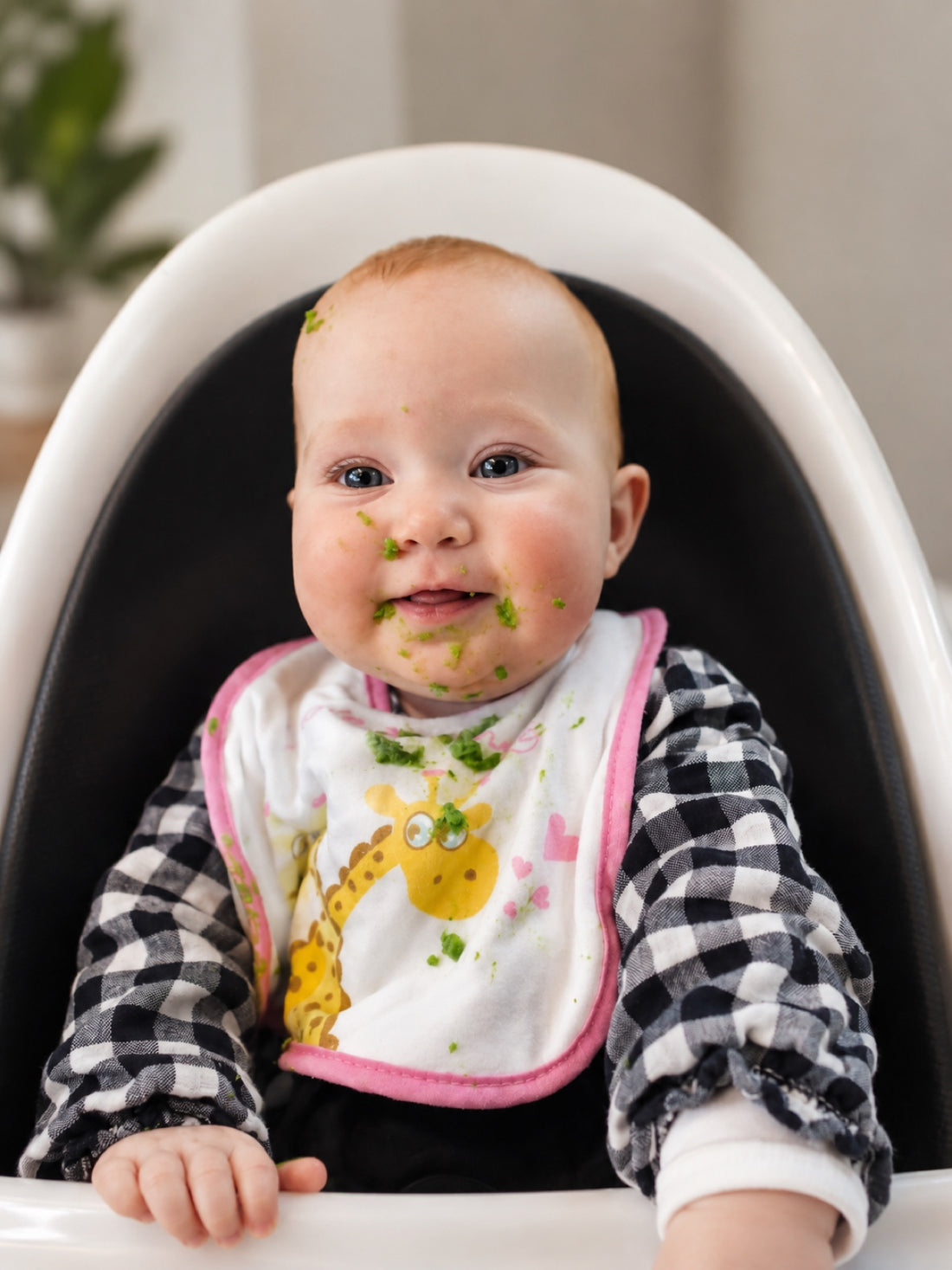 Baby in a highchair enjoying first solids